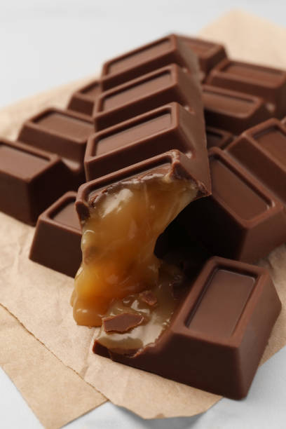 istock Tasty chocolate bars with caramel on white table, closeup 1806155321