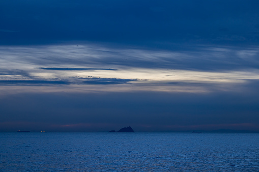 Sunset in the bay of the Aegean sea on the pier in Greece