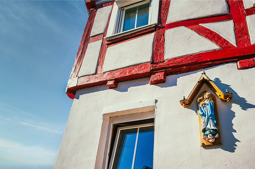 wooden holy sculpture at old tiber frame house in Fritzlar in Hessen  – Germany at sunny summer day