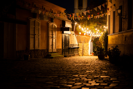 Old town cobblestone street at night. Illuminated.