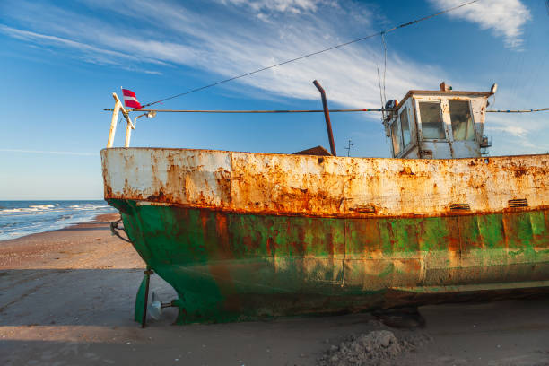 An early morning view on few old fishing ship and boats Jurmalciems beach near Liepaja in Latvia