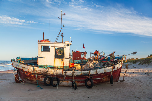 Early morning view of the old fishing ship on Jurmalciems beach near Liepaja in Latvia