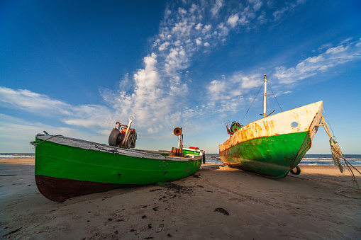 Early morning view of the old fishing ships on Jurmalciems beach near Liepaja in Latvia