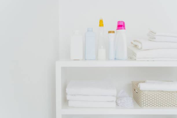 istock Neatly organized laundry shelf with clean towels and various detergents 1806165771