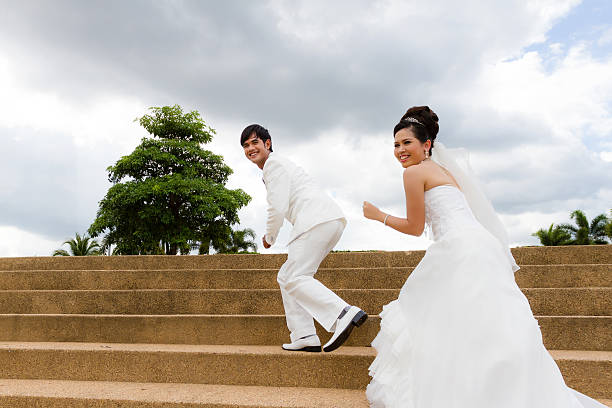 Young newly married couple chasing each other