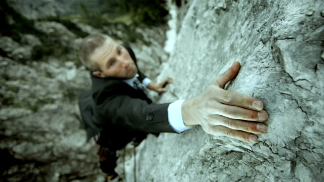 HD: Businessman Reaching For The Next Hold