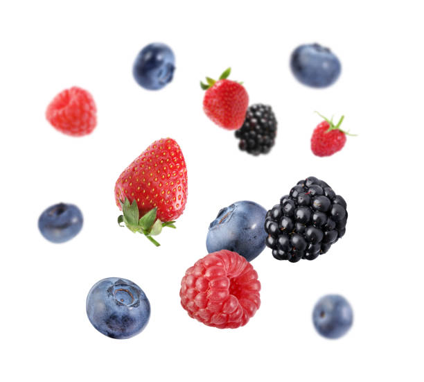 istock Fresh ripe blueberries, strawberries, raspberries and blackberries falling on white background 1806180500