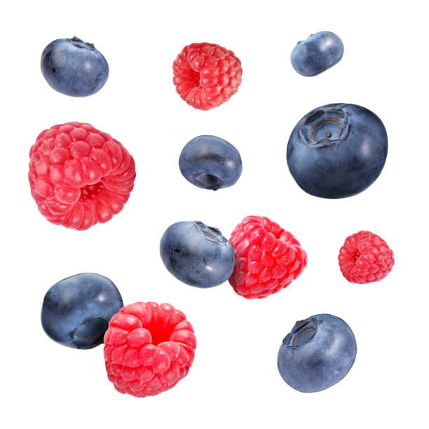 istock Fresh ripe blueberries and raspberries falling on white background 1806180523