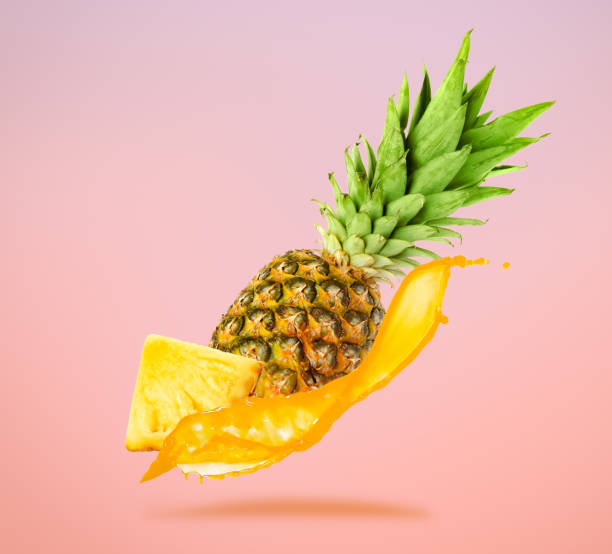 istock Ripe pineapple with splashing juice on color background 1806180817