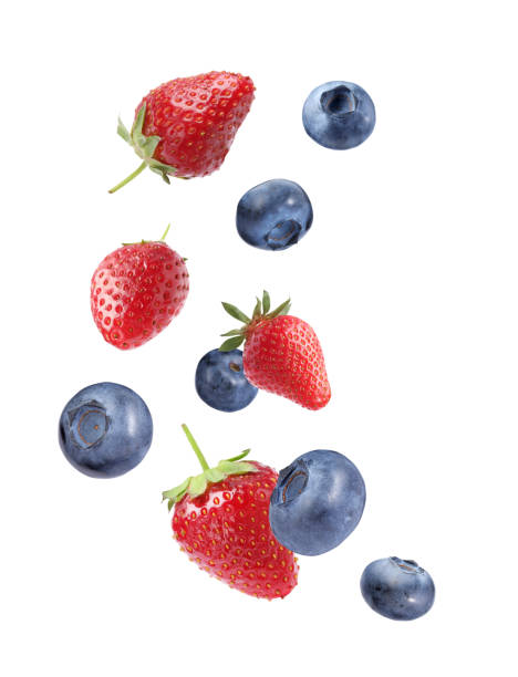istock Fresh ripe blueberries and strawberries flying on white background 1806181052