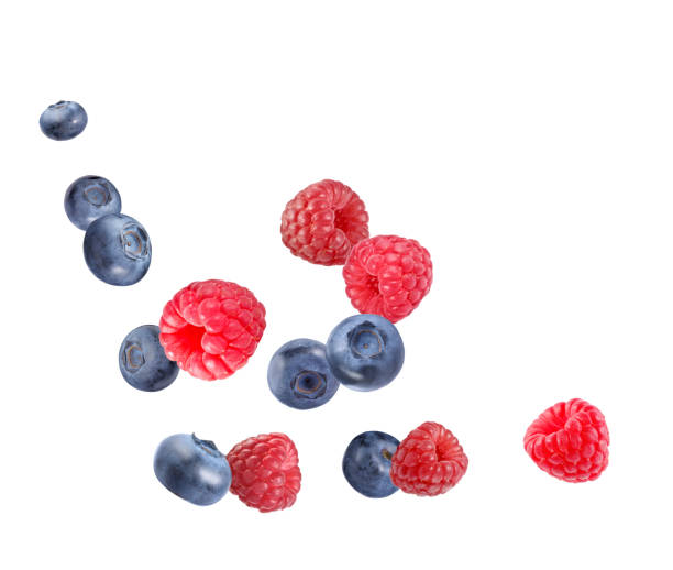 istock Fresh ripe blueberries and raspberries falling on white background 1806182002