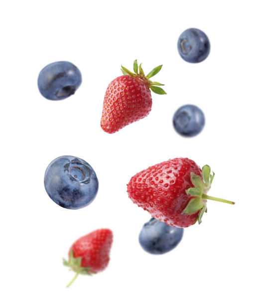 istock Fresh ripe blueberries and strawberries falling on white background 1806183338