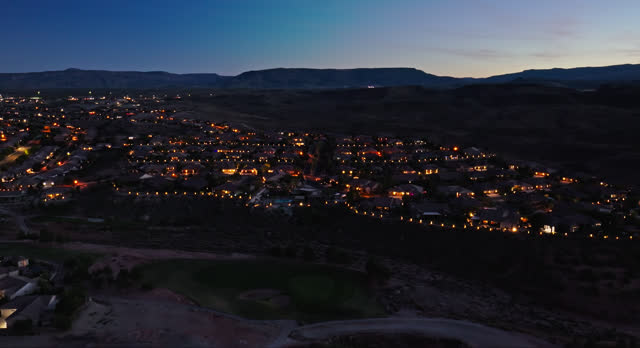 Suburban Housing Development Encroaching on Desert in St. George, UT at Night - Aerial