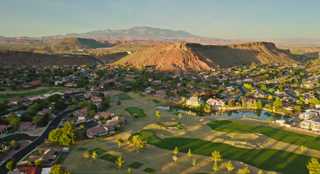 Drone Flight Over Suburban Houses Built Around Golf Course in St. George, Utah at Sunset
