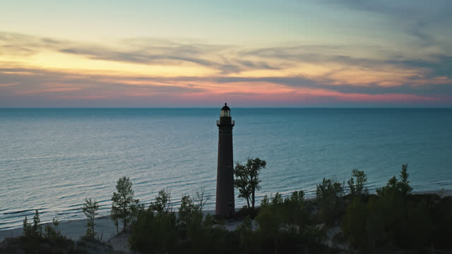 Descending Drone Shot of Little Sable Point Light on Shore of Lake Michigan