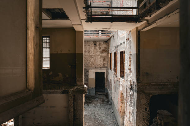 istock Abandoned, damaged interior building with falling apart brick walls and debris 1806202337