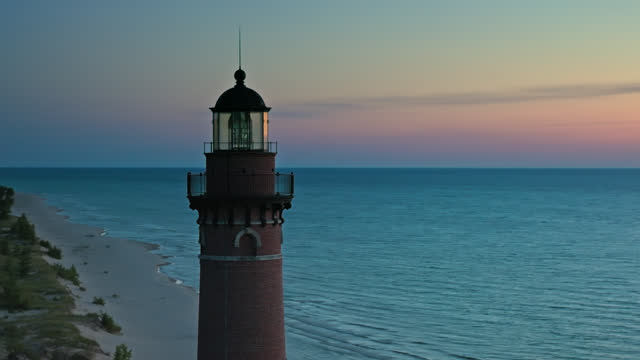 Drone Shot Orbiting Little Sable Point Light on Shore of Lake Michigan