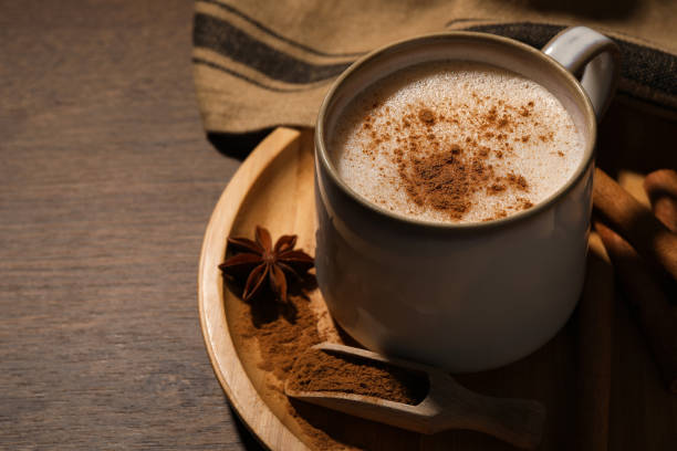 istock Cup of delicious eggnog with spices on wooden table. Space for text 1806206148