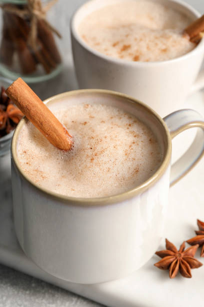 istock Cups of delicious eggnog with anise and cinnamon on light grey table 1806206737