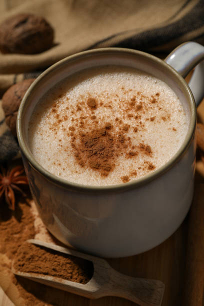 istock Cup of delicious eggnog with spices on wooden table 1806206741