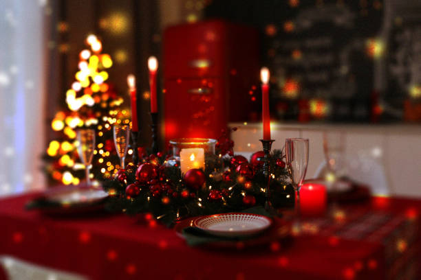 istock Christmas table setting for festive dinner, bokeh effect. Candles, wreath, plates and glasses on table indoors 1806207277