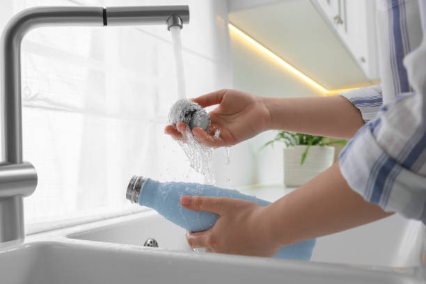 istock Woman washing thermo bottle in kitchen, closeup 1806220093