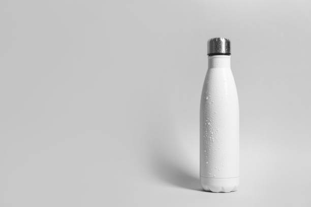 istock Stylish white thermo bottle with water drops on light grey background, space for text 1806221217