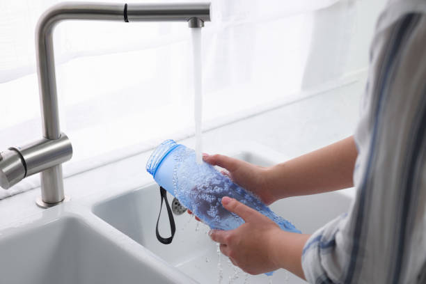 istock Woman washing thermo bottle in kitchen, closeup 1806221727