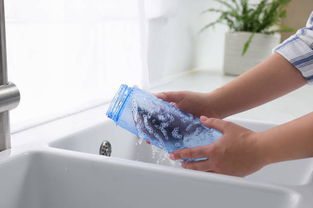 istock Woman washing thermo bottle in kitchen, closeup 1806221733