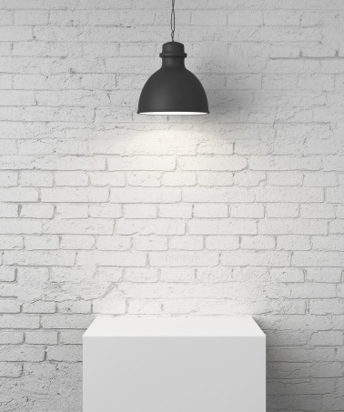 white brick room with podium and lamp