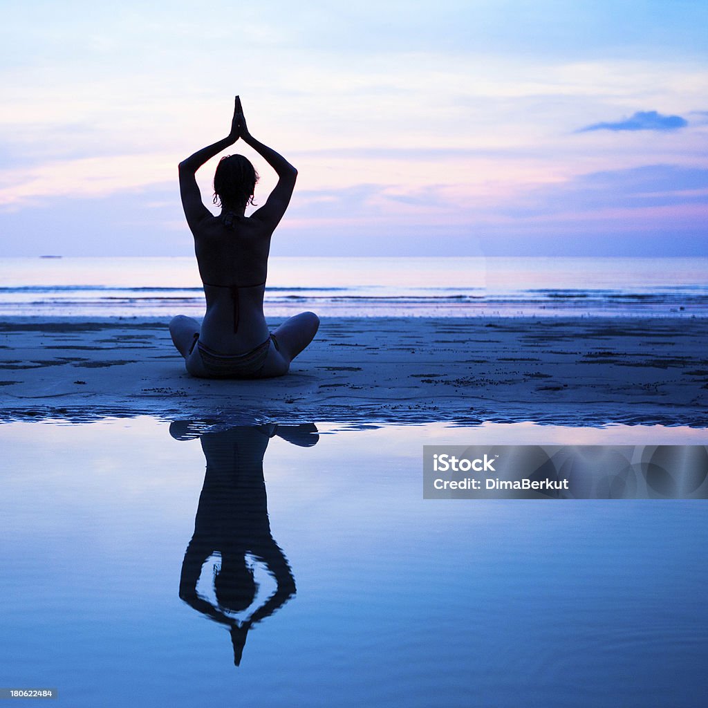 Yoga, harmony of health Yoga, harmony of health - silhouette young woman on the beach at sunset. Adult Stock Photo