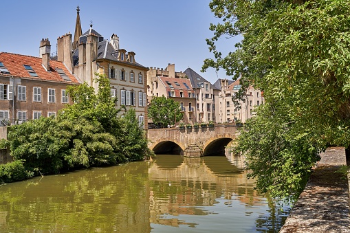This photograph captures a scenic view of an old town, with traditional buildings on either side of a river