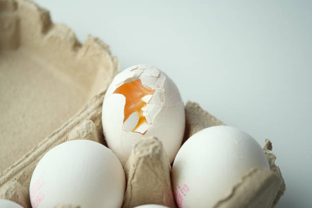 istock one broken egg with yellow yolk stored in carton container 1806230250
