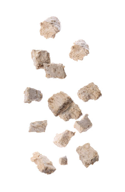 istock Pieces of tasty halva falling on white background 1806231949