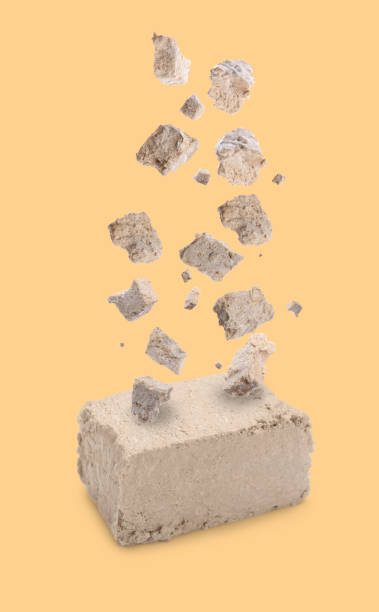 istock Pieces of tasty halva falling on pale orange background 1806231978