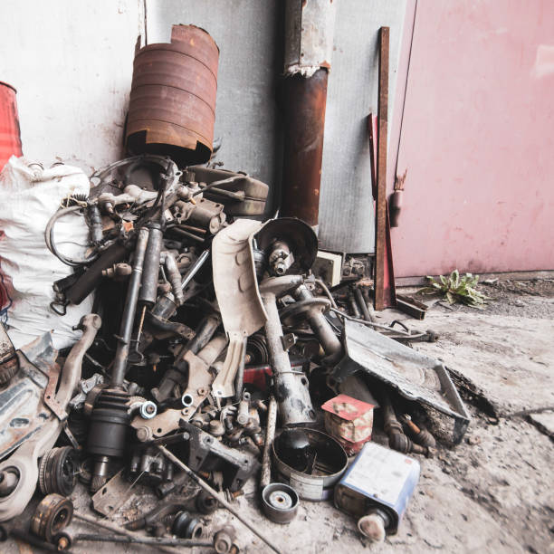 a pile of removed used car parts at a technical service station stacked for scrap metal - rust metal imagens e fotografias de stock