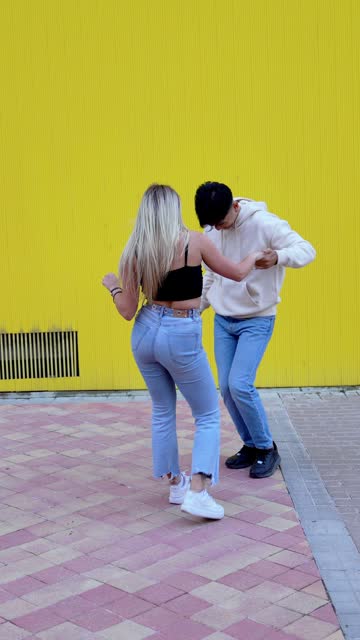 Vibrant Urban Street Dance: Chinese Man and Blonde Caucasian Woman in Colorful Latin Dance
