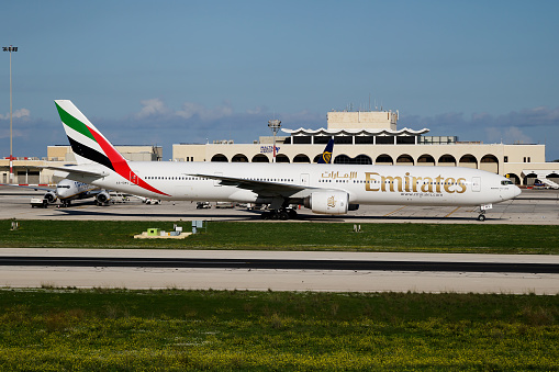 Luqa, Malta - November 22, 2016: Emirates passenger plane at airport. Schedule flight travel. Aviation and aircraft. Air transport. Global international transportation. Fly and flying.