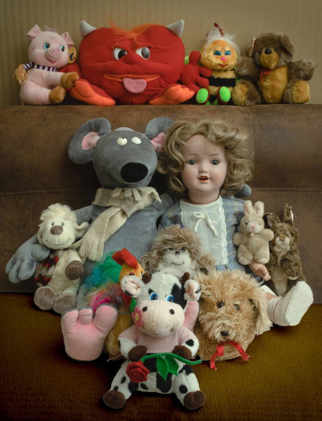 Soft toys and a doll on the couch