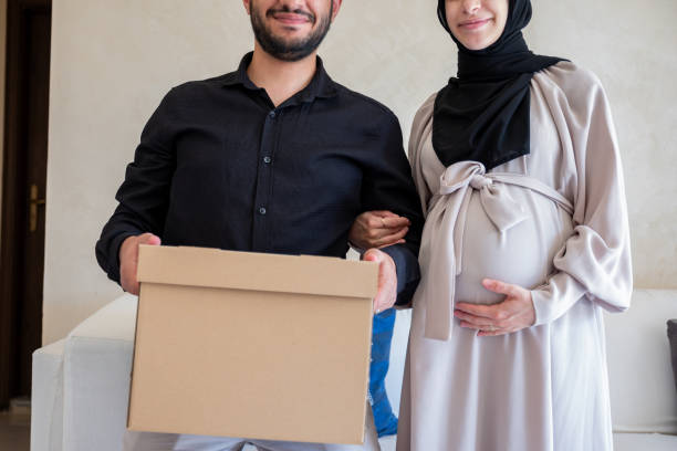 istock Couples holding box in home preparing items for their new child with mock up space 1806261079