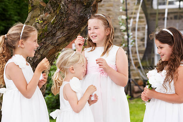 istock Group Of Bridesmaids Blowing Bubbles In Garden 180626698