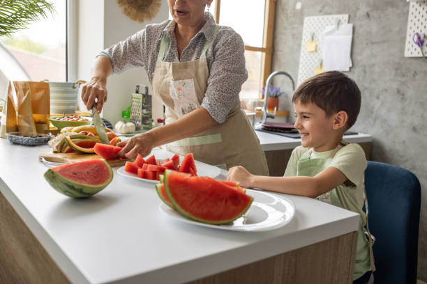 istock Boy with grandmother in kitchen 1806272655