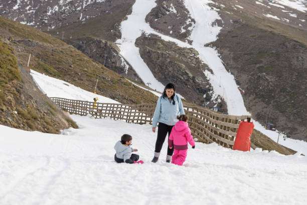istock Family playing in the snow with a sled 1806280824