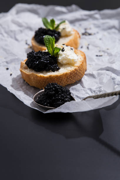 istock Crispy canapes with black caviar, soft cream cheese 1806281911