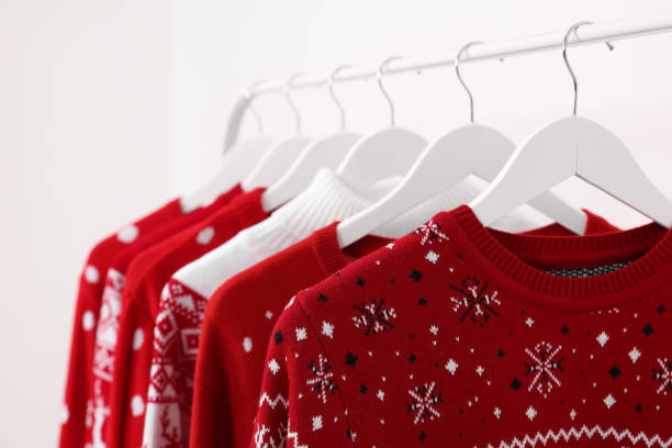 istock Rack with different Christmas sweaters on white background, closeup 1806283528