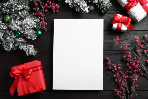 istock Flat lay composition with blank paper, gift boxes and Christmas decor on wooden table, space for text. Letter to Santa 1806283545