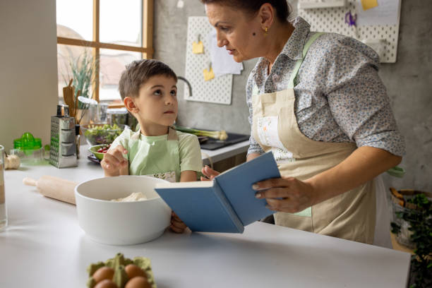 istock Boy helping grandmother make lunch 1806292124