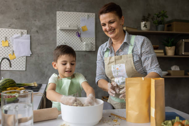 istock Woman kneading dough with grandson 1806292677