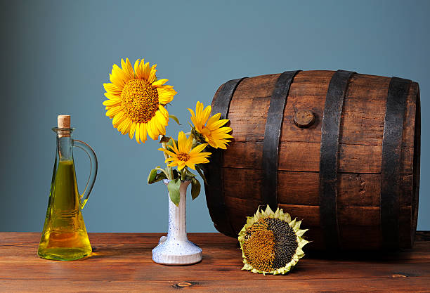 Wooden barrel and sunflowers in a vase