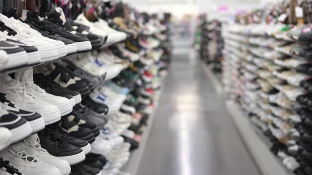 Shelves with sneakers in a store.